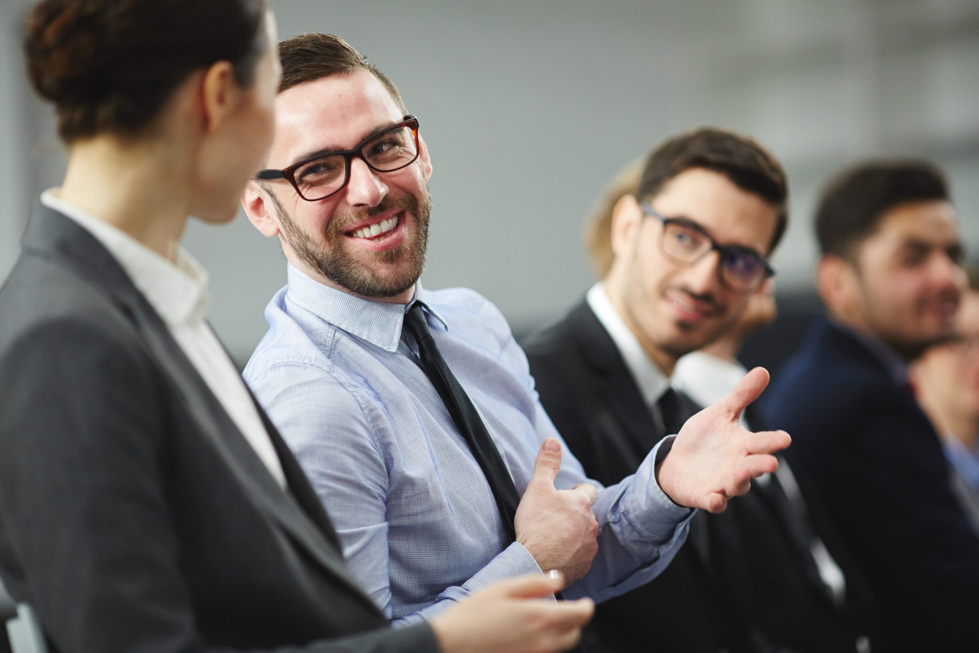 Colleagues talking and smiling in a meeting