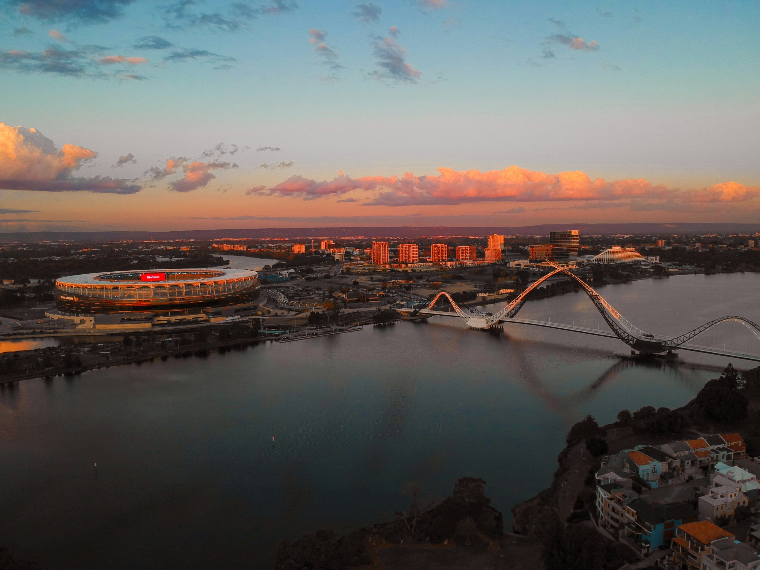 Home Aerial view of the Swan River, Matagarup Bridge and the stadium in Perth at sunset