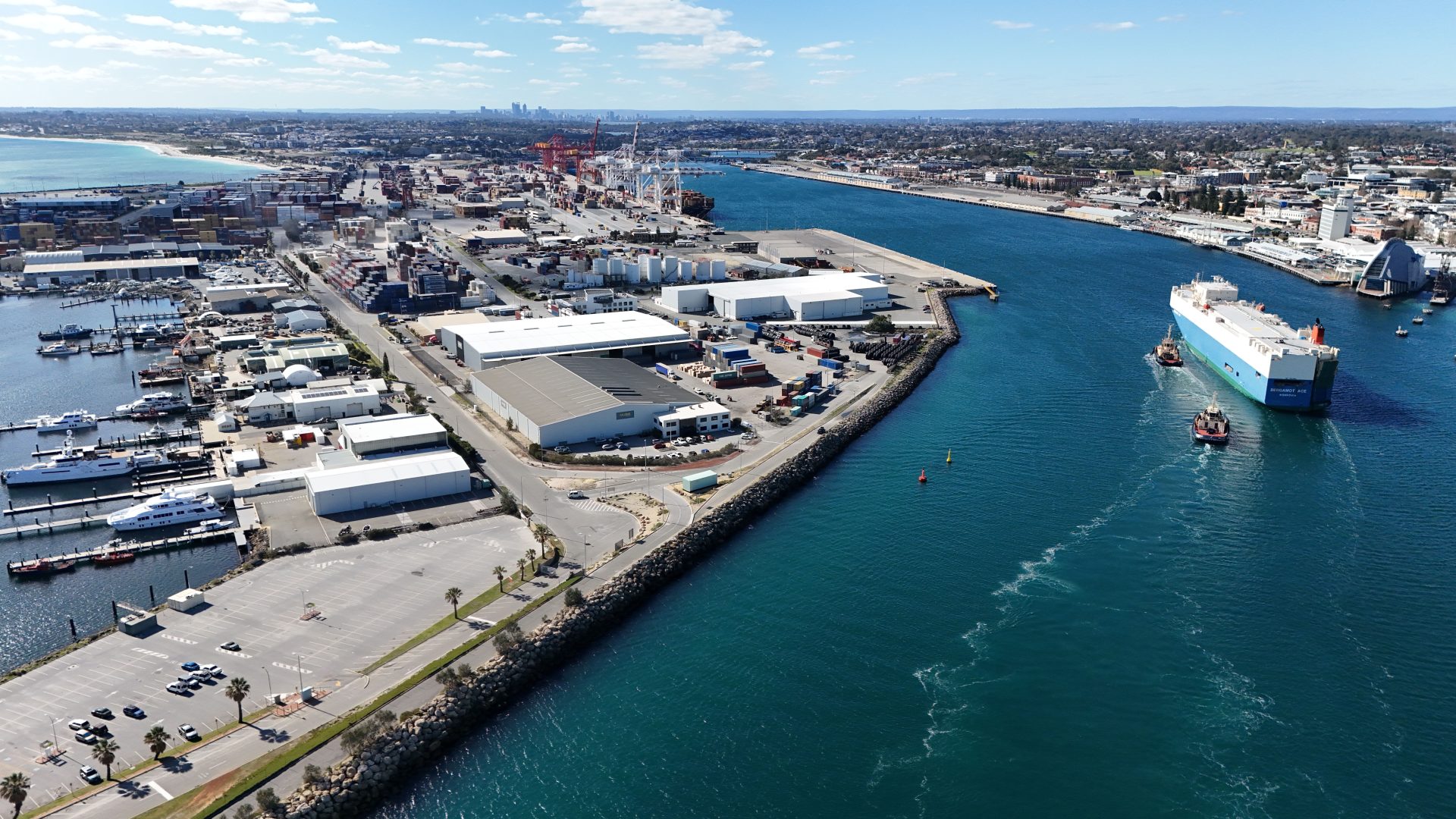 Aerial view of a working port with a ship leaving the harbour