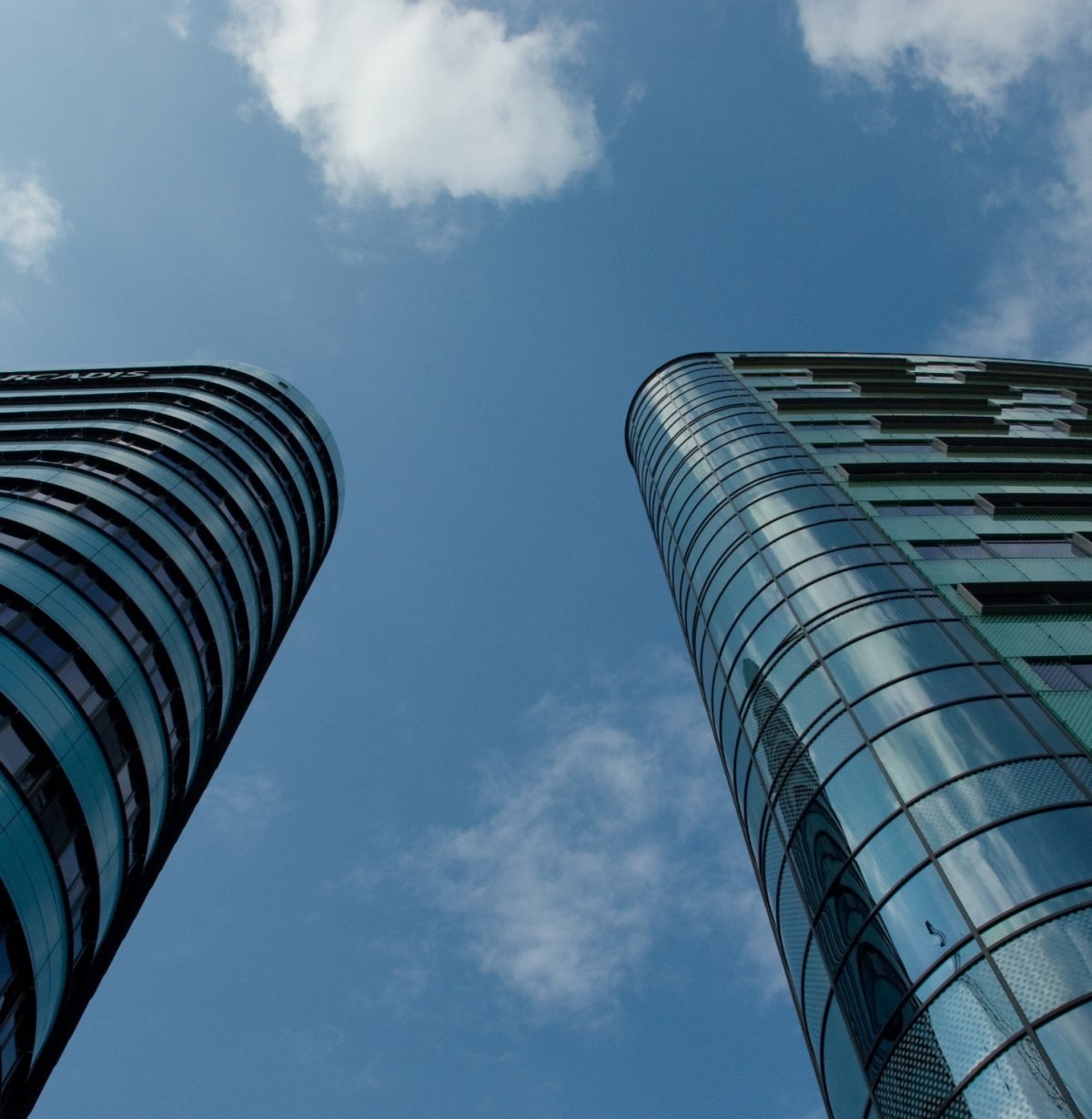 Our People Glass office towers against a blue sky