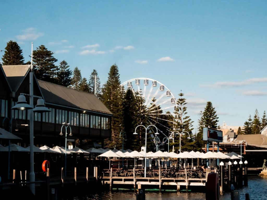 Home Waterfront buildings and a ferris wheel beside a harbour in Western Australia